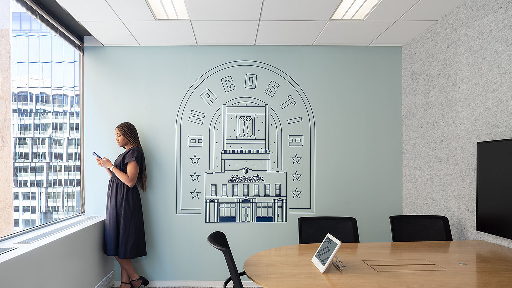 A person standing in front of a large white board.